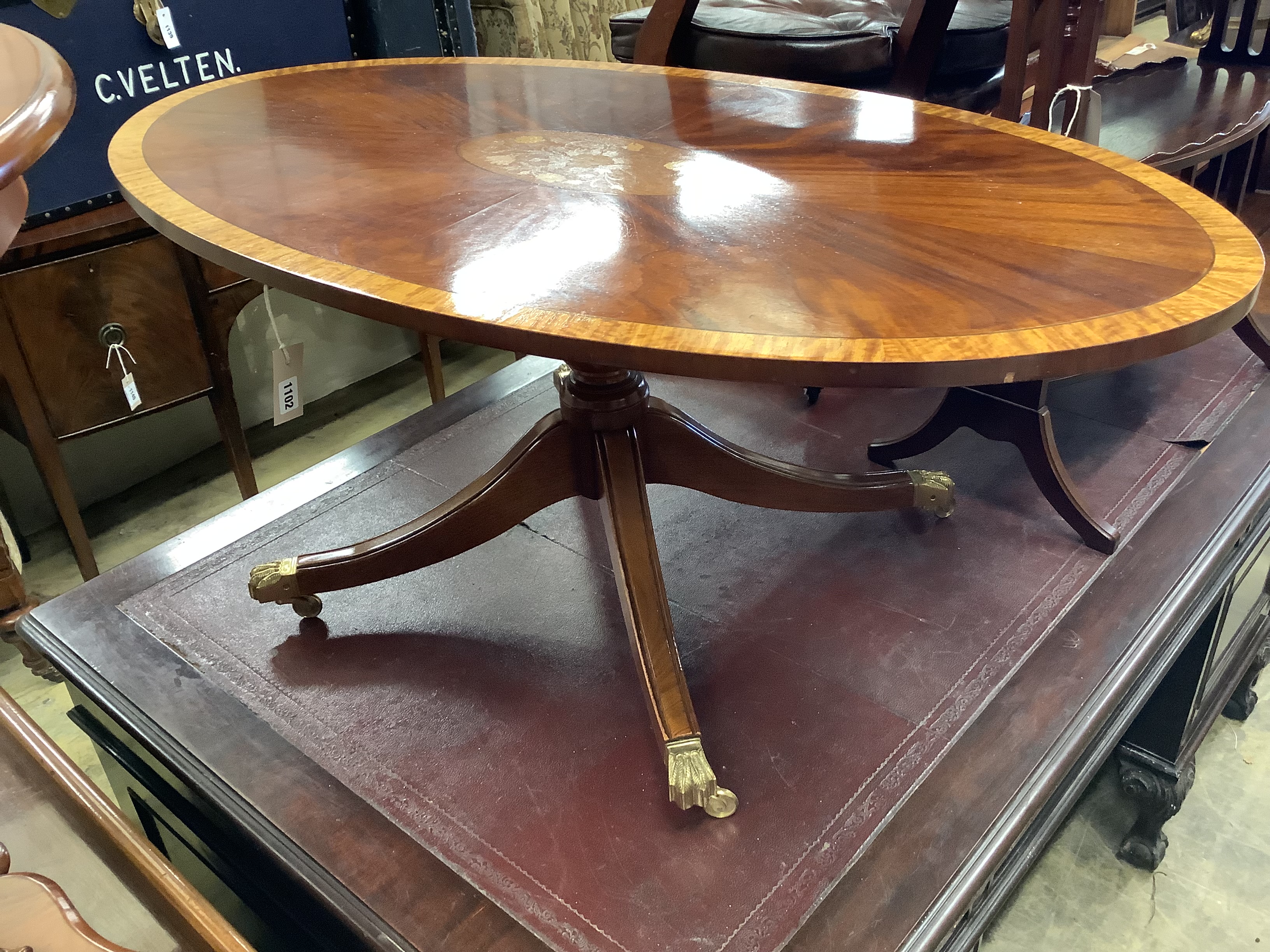 A reproduction low oval mahogany coffee table, length 120cm, depth 68cm, height 50cm together with an oval mahogany three-tier occasional table